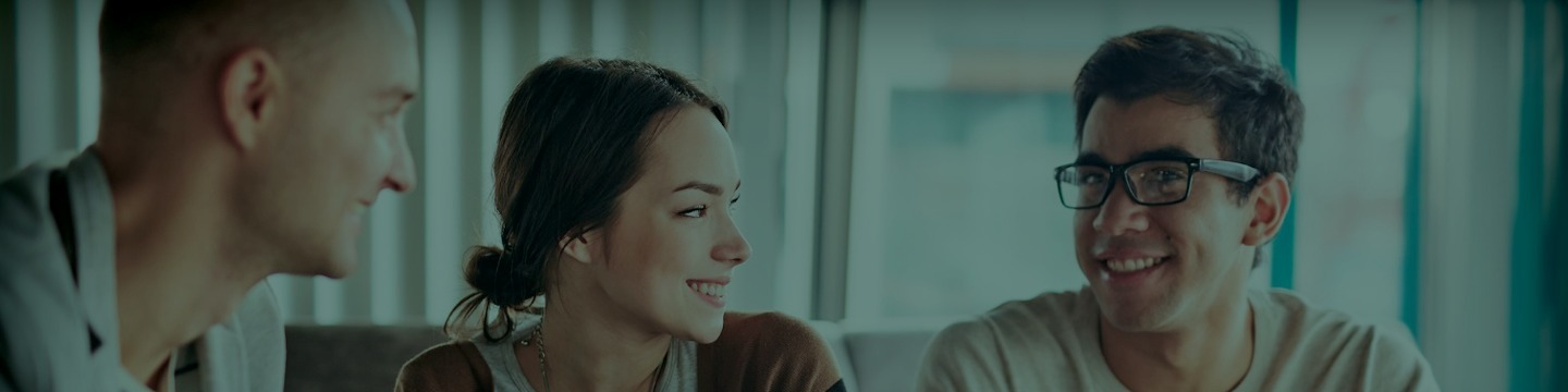 Three people sitting and smiling
