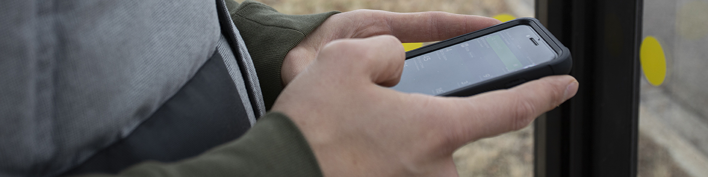 A person using their cell phone to send a message. 