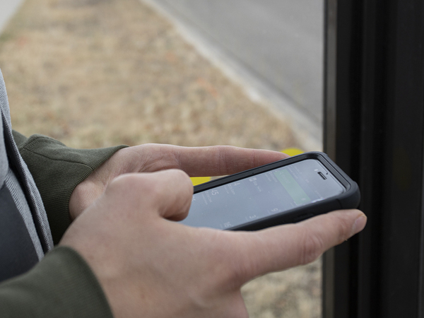 A person using their cell phone to send a message. 